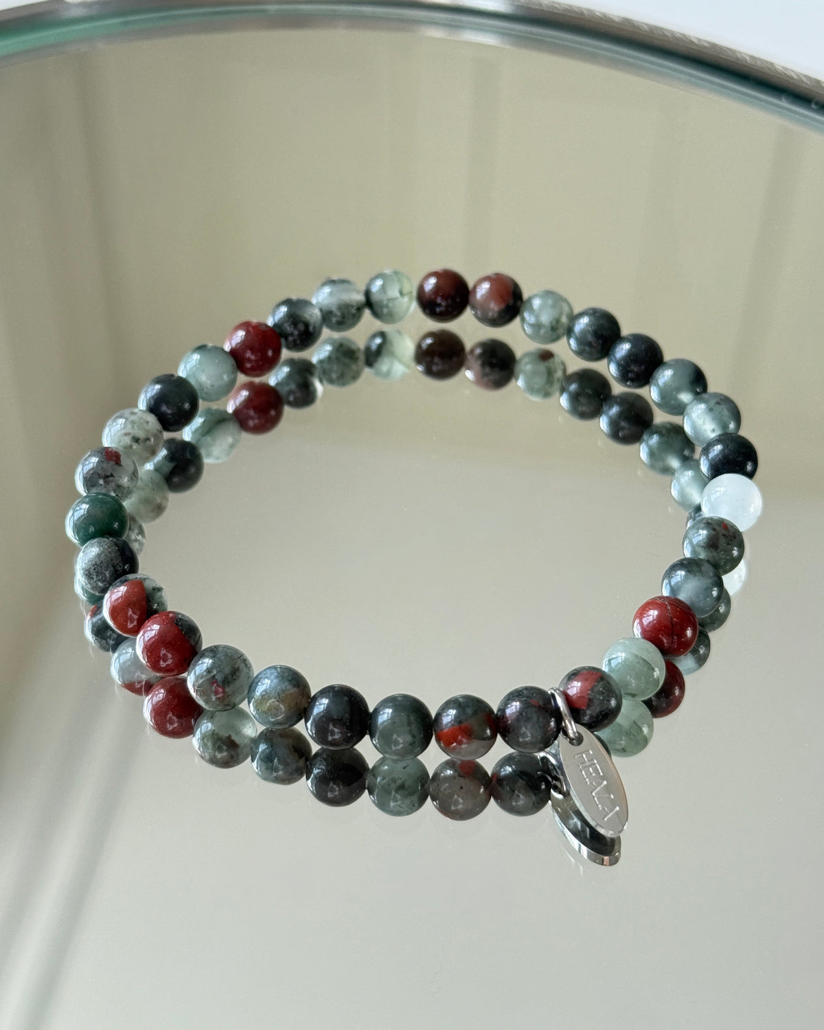 Multicolored beaded bracelet on a reflective surface